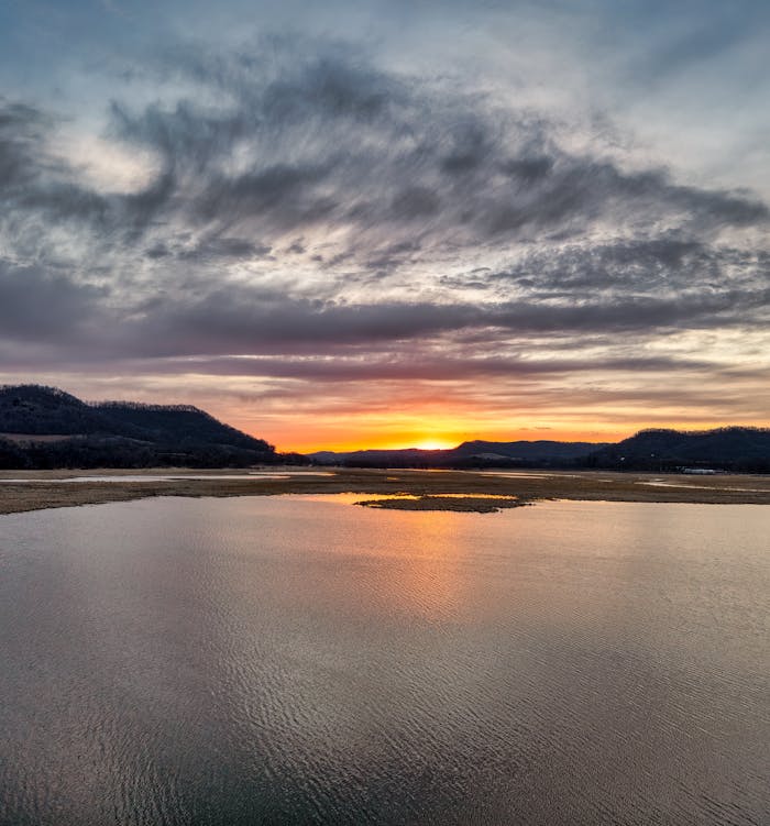 Captivating sunset at Alma Lake, WI, with vibrant sky reflections on calm water.